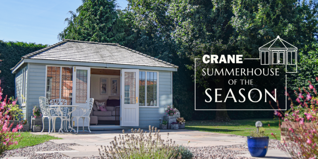 A blue Cley summerhouse with logo for Summerhouse of the Season to the right